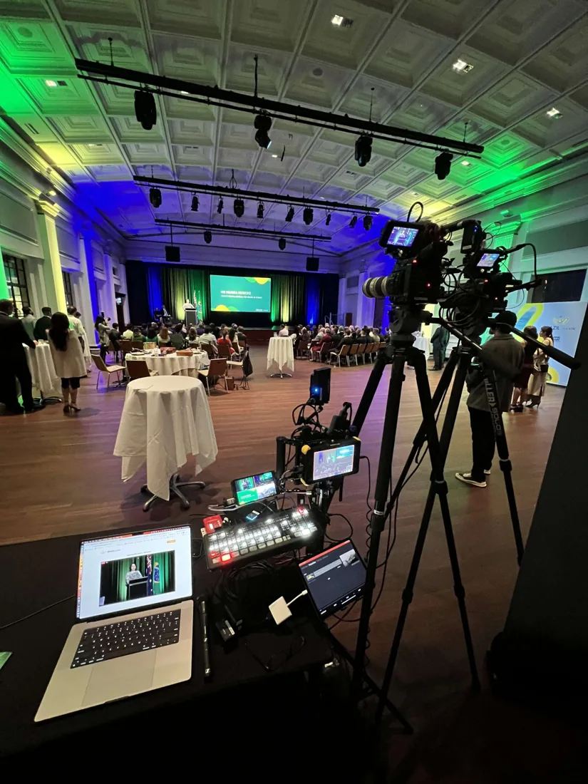 ECKOmedia camera, switcher and laptop set up at the back of a lit ballroom during a gala event
